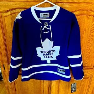 Official NHL Reebok Medium Women’s Maple Leafs Jersey. Brand new, with tags.